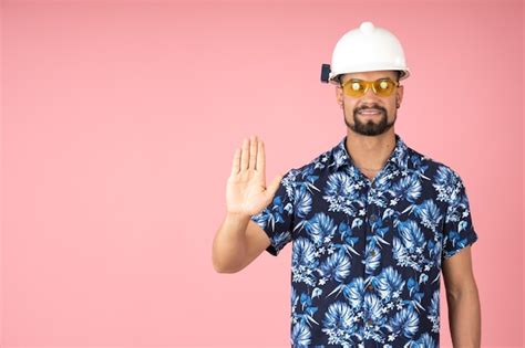 Premium Photo Smiling Man Wearing A Helmet And Pointing To Stop With