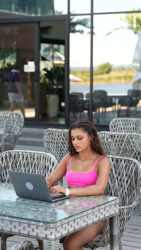 Woman In Bikini Sits Outside Using A Laptop 13153546 Stock Video At Vecteezy