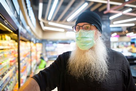 Premium Photo Mature Bearded Hipster Man With Mask Shopping With