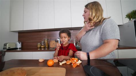 Happy Mommy And Daughter Girl Having Fun While Cooking In Kitchen