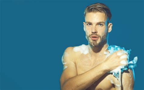 Premium Photo Macho Washing Naked Chest With Sponge Muscular Guy Covered With Foam Mens