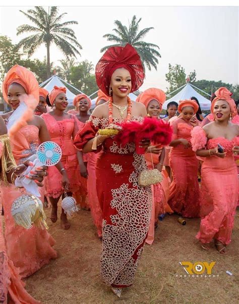 A Group Of Women Dressed In Red And Orange