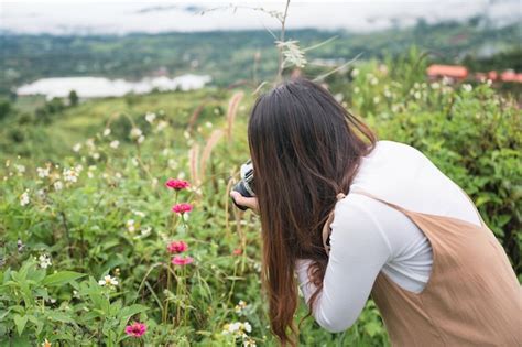 Premium Photo Amateur Asian Woman Taking Photo With Retro Film Camera Among The Flower Garden