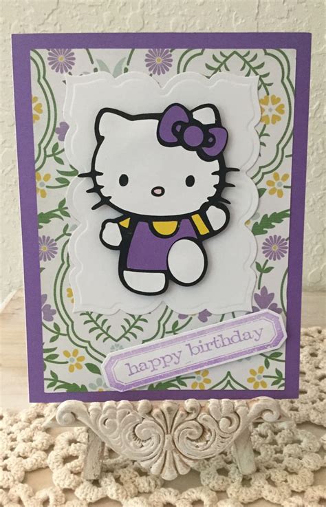 a hello kitty birthday card sitting on top of a table