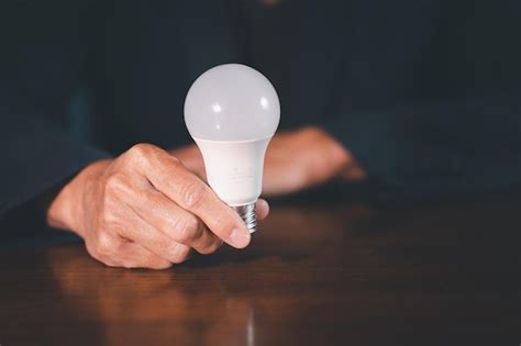 Premium Photo Man Hand Hold Light Bulb