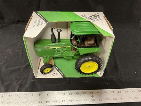 John Deere Row crop tractor - Legacy Auction Company