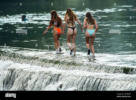 People Enjoy The Water At Warleigh Weir On The River Avon Near Bath In