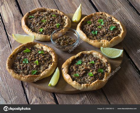 Arabic meat sfiha over a wooden table. Top view. Stock Photo by ...