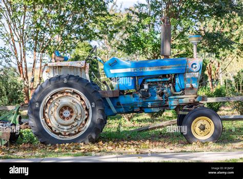 A well used blue Ford farm tractor in Wainscott, NY Stock Photo - Alamy