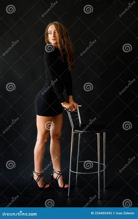 Seductive Pose Of Dark Haired Woman Wearing A Black Bikini Stock Photo Image Of Mobile Look