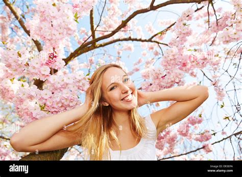 Happy Blonde Woman At Japanese Flowering Cherry Blossom In Spring Stock Photo Alamy