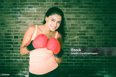 Beautiful Young Indian Woman Wearing Boxing Gloves Smiling To Camera