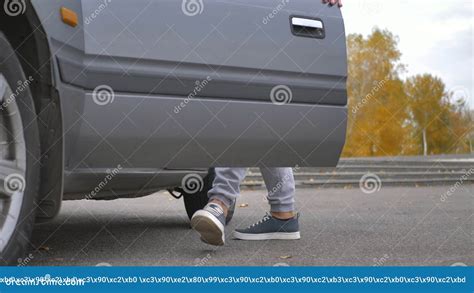 A Male Driver Opens The Driver S Seat Door Gets Behind The Wheel Of A Car And Closes The Door