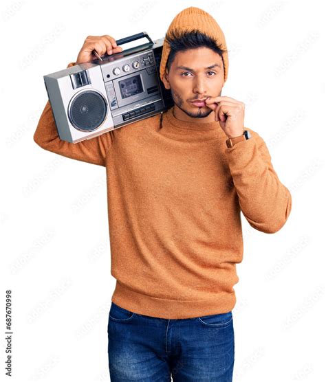 Handsome Latin American Young Man Holding Boombox Listening To Music