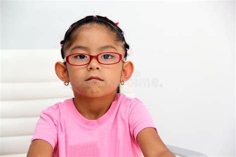 Brunette Latin Girl Shows Her Red Glasses To See Better Because She Has Myopia And Astigmatism