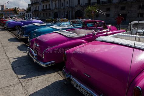 Bright Colored Classic And Vintage Cars In A Parking Lot In Havana Cuba