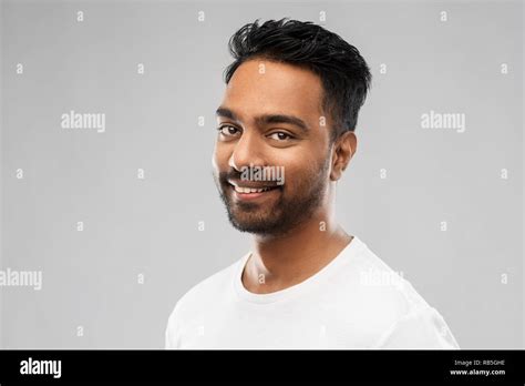 Smiling Young Indian Man Over Gray Background Stock Photo Alamy