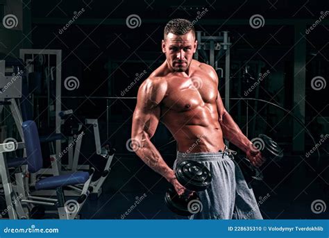 Sportsman With Naked Torso Maintaining Healthy Lifestyle Standing Leaning On Trainer Holding
