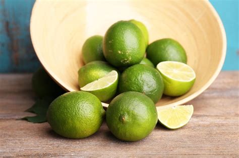 Premium Photo Fresh Juicy Limes In Bowl On Old Wooden Table