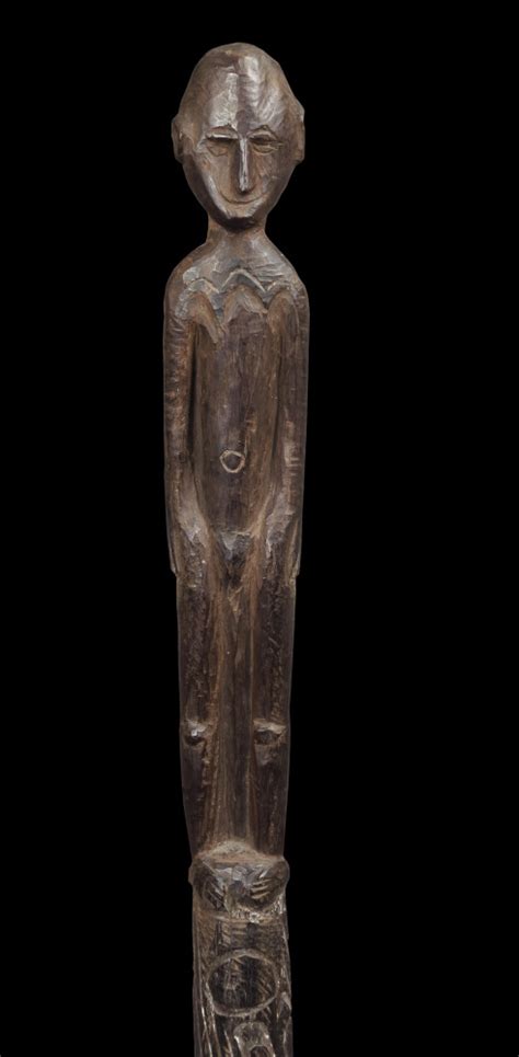 A Wooden Statue Is Shown Against A Black Background With The Image Of A