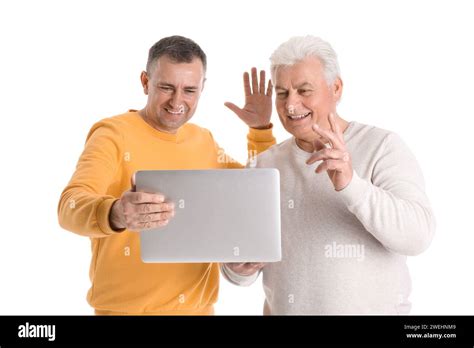 Mature Brothers With Laptop Video Chatting On White Background Stock Photo Alamy