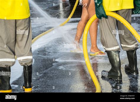 Man Wetting A Woman S Feet In The Middle Of The Street Hot Sunny Day Dirty Feet Cleaning