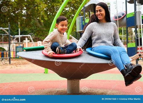 Lesbian Couple Laughing While Playing With Their Son In The Playground Stock Photo Image Of