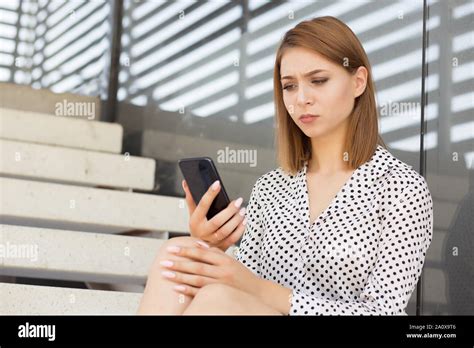 Upset Stressed Woman Holding Cellphone Frustrated With The Message She