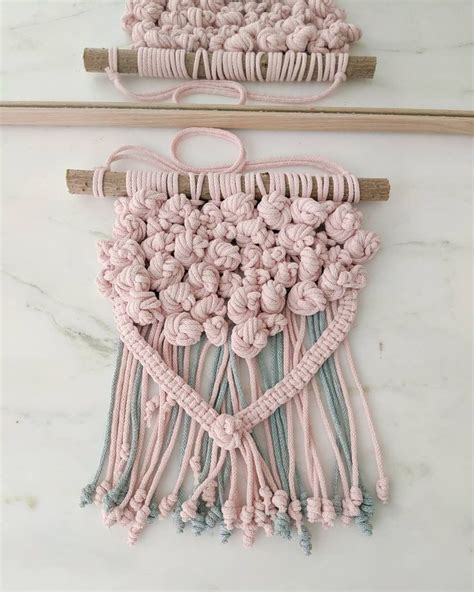 Crocheted Macrame With Pink And Blue Yarn Hanging From The Side On A