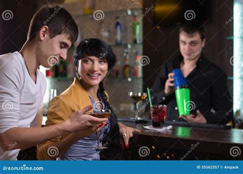 Laughing Couple Drinking At A Pub Counter Royalty Free Stock