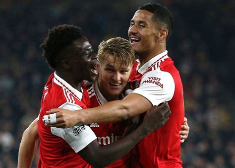 epl odegaard double sends arsenal  points clear