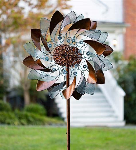 This Handsome Bronze Metal Flower Wind Spinner Features Alternating