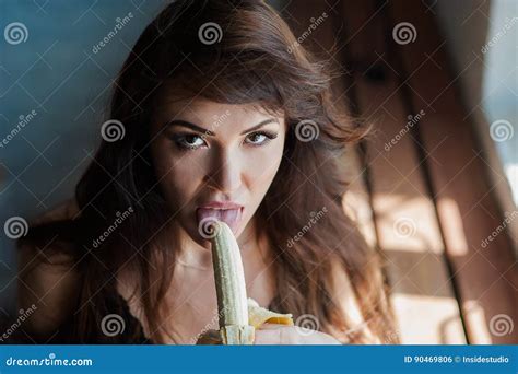 Beautiful Erotic Brunette Sucking And Eating A Banana Stock Photo Image Of Woman Face 90469806