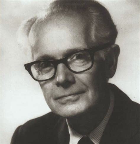 an old black and white photo of a man wearing glasses