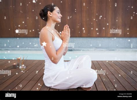 Content Brunette In White Sitting In Lotus Pose Stock Photo Alamy
