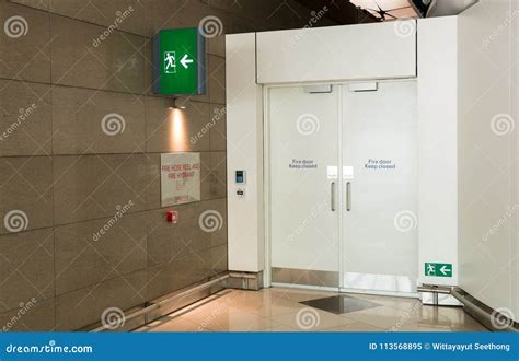 Fire Exit Way Door And Fire Exit Sign Light Box In The Airport Terminal