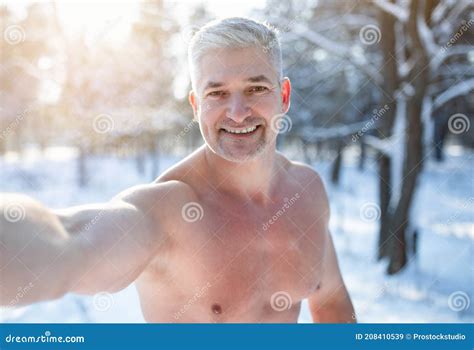 Smiling Mature Guy With Naked Torso Taking Selfie At Snowy Winter Park Seasonal Pastimes Stock