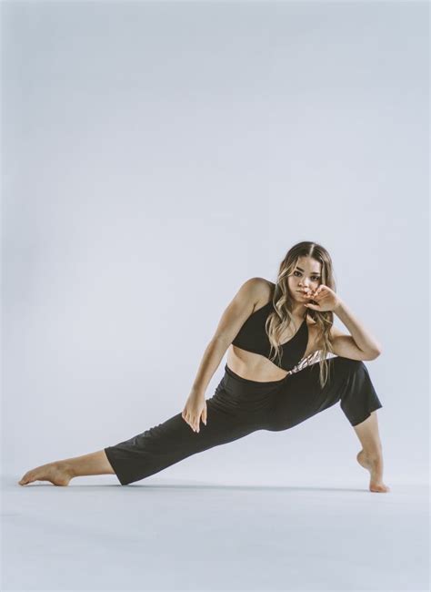 A Woman In Black Is Doing Yoga Poses