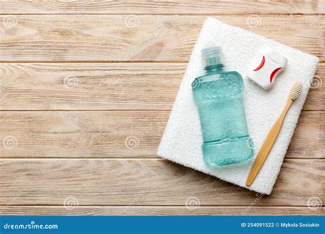 Mouthwash And Other Oral Hygiene Products On Colored Table Top View