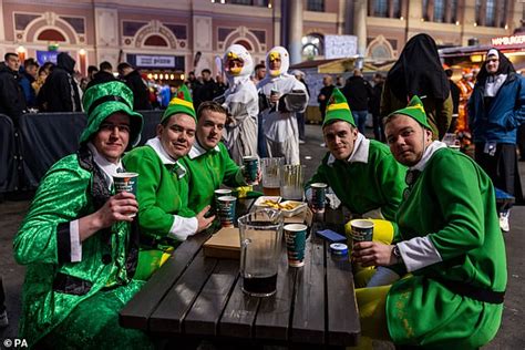 Thousands of boozy darts fans descend on Ally Pally in fancy dress - I