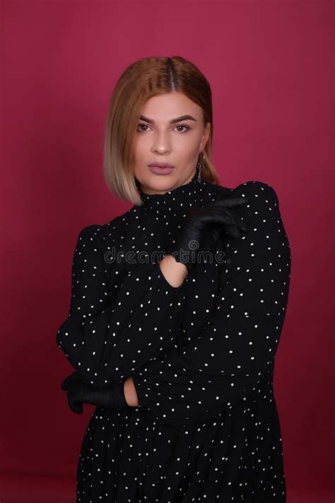 Portrait Of A Natural Blonde Make Up Artist Girl With Blonde Hair In A Black Dress In Black