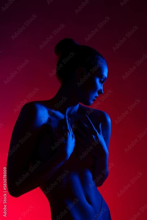 Sensual Naked Woman With Hands On Breast In Neon Light Stock Photo Adobe Stock