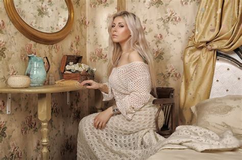 Beautiful Blonde With A White Knitted Sweater Sits At A Table Stock Photo Image Of Natural
