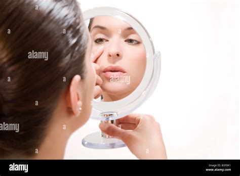 Young Woman Looking Into Mirror Portrait Stock Photo Alamy