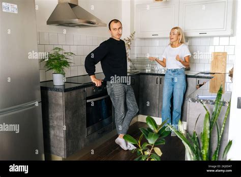 Wide Shot Of Angry Emotional Blonde Woman Scolding Raising Voice Shouting At Ignoring Tired