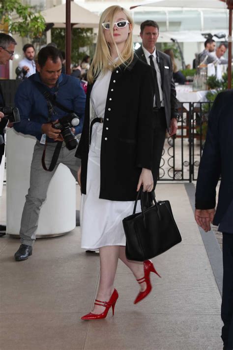 Elle Fanning In A White Dress Arrives At The Martinez Hotel In Cannes 05202019 Lacelebsco