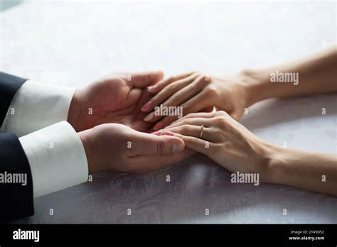 Intimate moment of two hands intertwined, showcasing a delicate ...