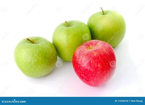 Red Apple Leading A Group Of Three Apples Royalty Free Stock Image