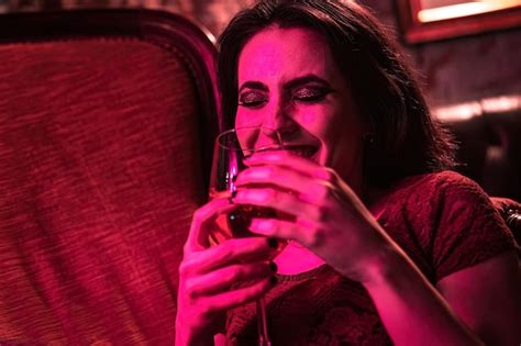 Premium Photo Happy Brunette Rebel Girl Sipping Drink On Vintage Armchair In Closeup Shot