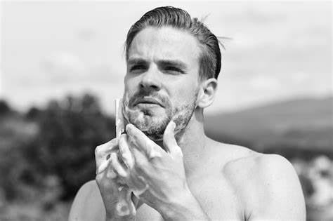 Premium Photo Man Shaving Naked With Mountains On Background